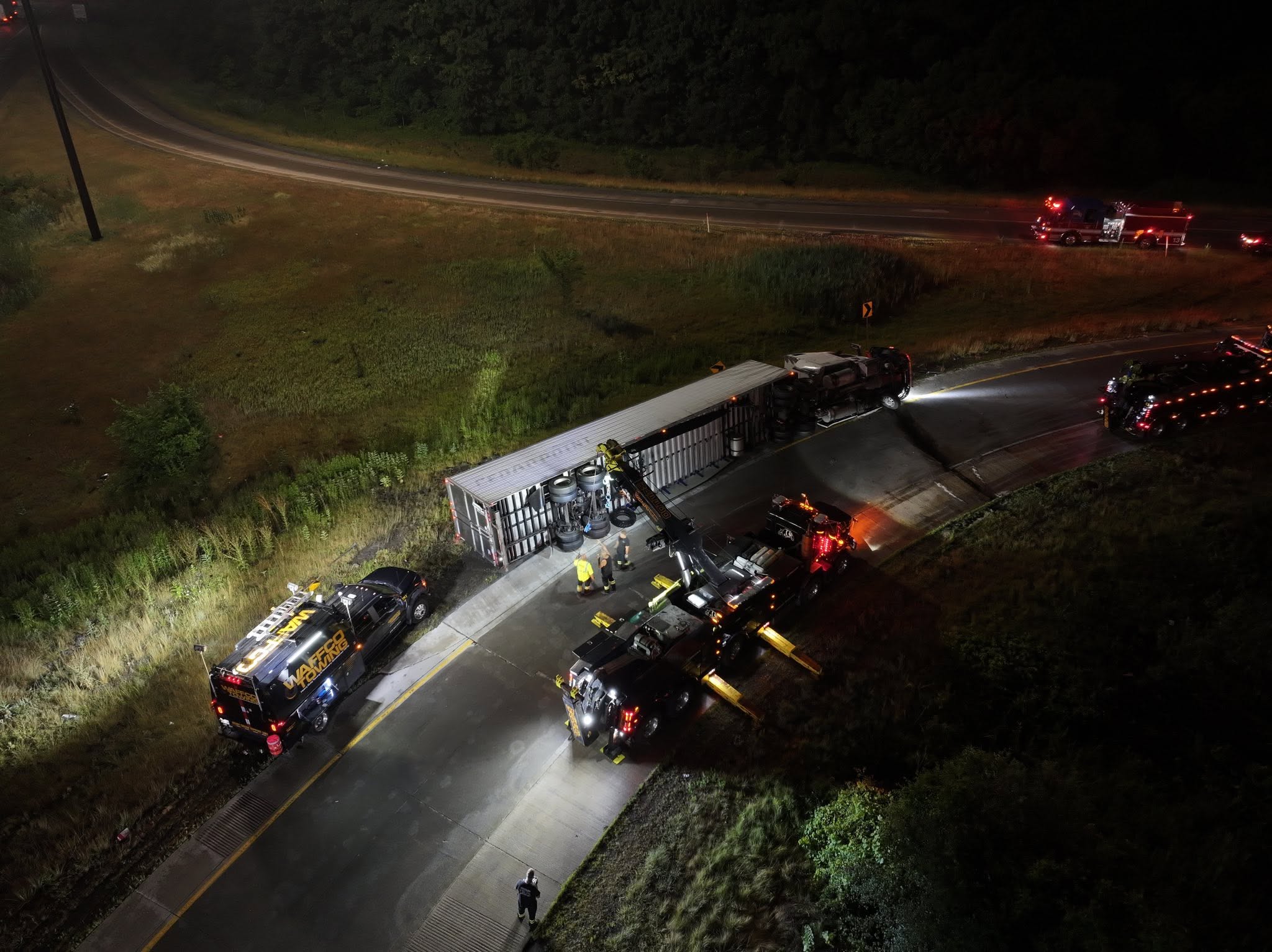 Nighttime heavy recovery with Waffco trucks and scene lighting