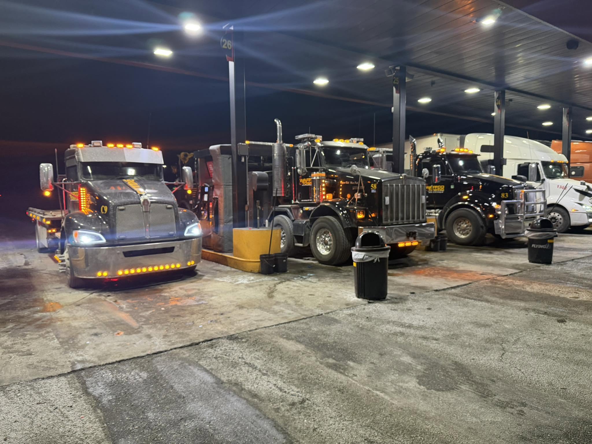 Waffco trucks staged at a fuel stop at night