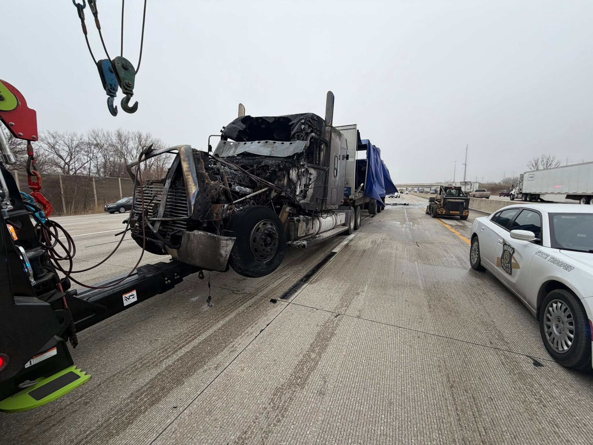 Burned tractor recovery with police vehicle and recovery equipment