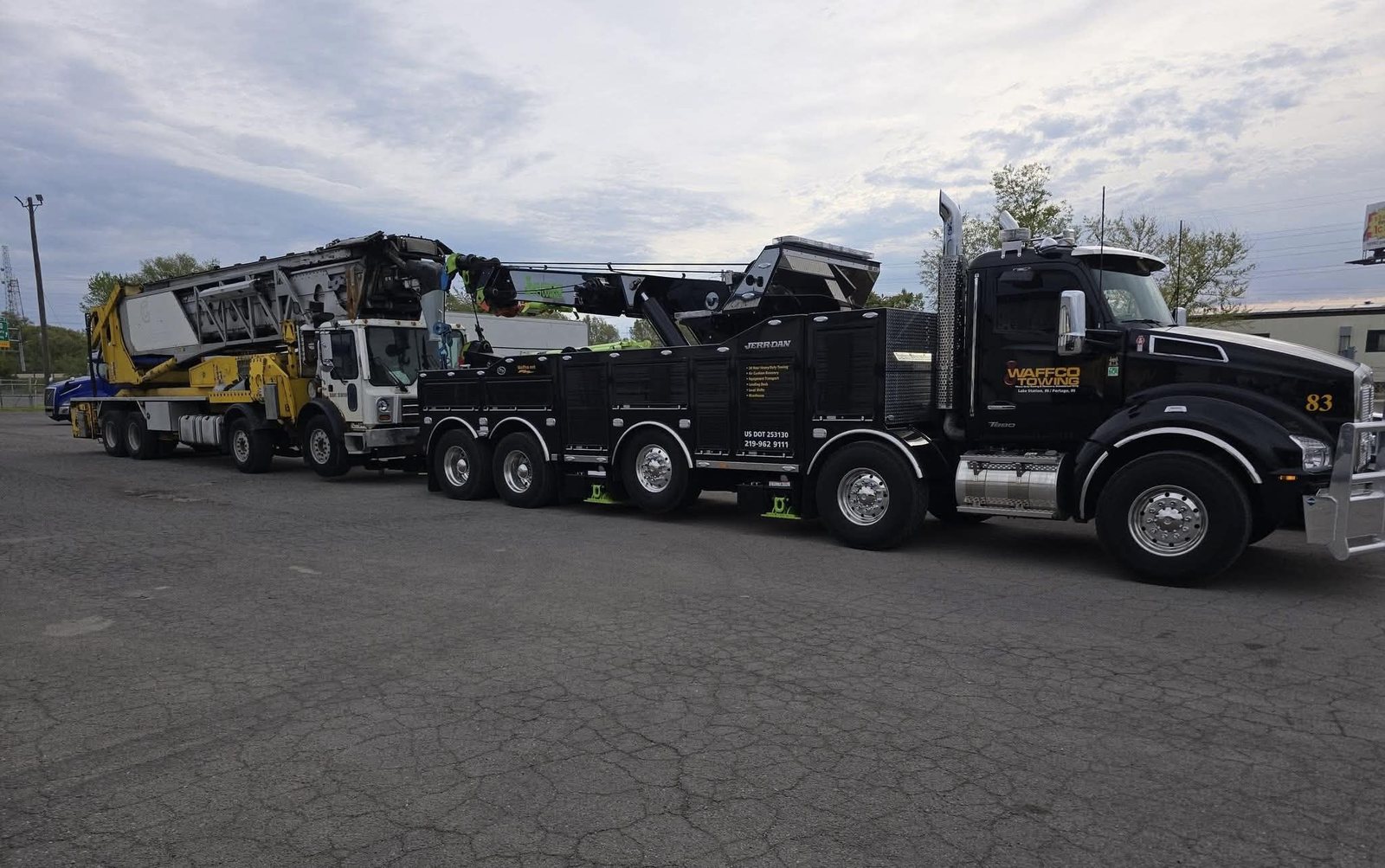 Waffco heavy wrecker transporting industrial equipment